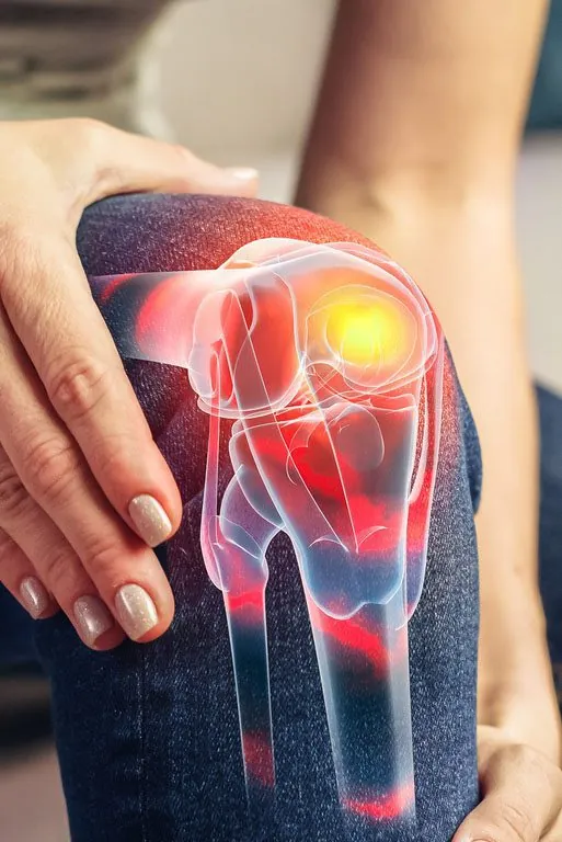 A clinician examining a patient's knee