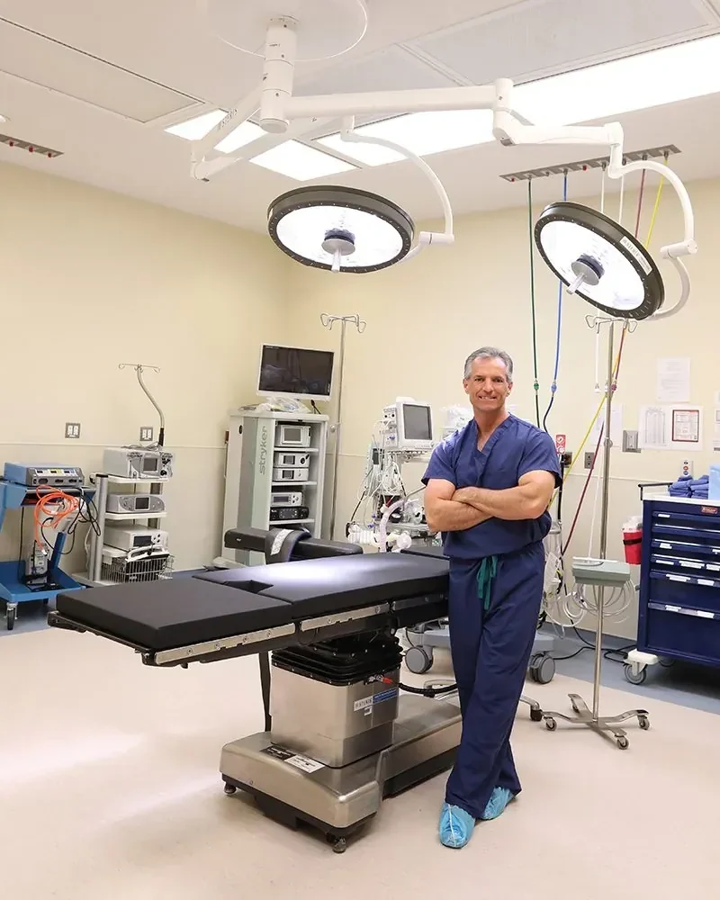 Dr. Thomas Perkins in scrubs in an operating room at the on-site surgery center