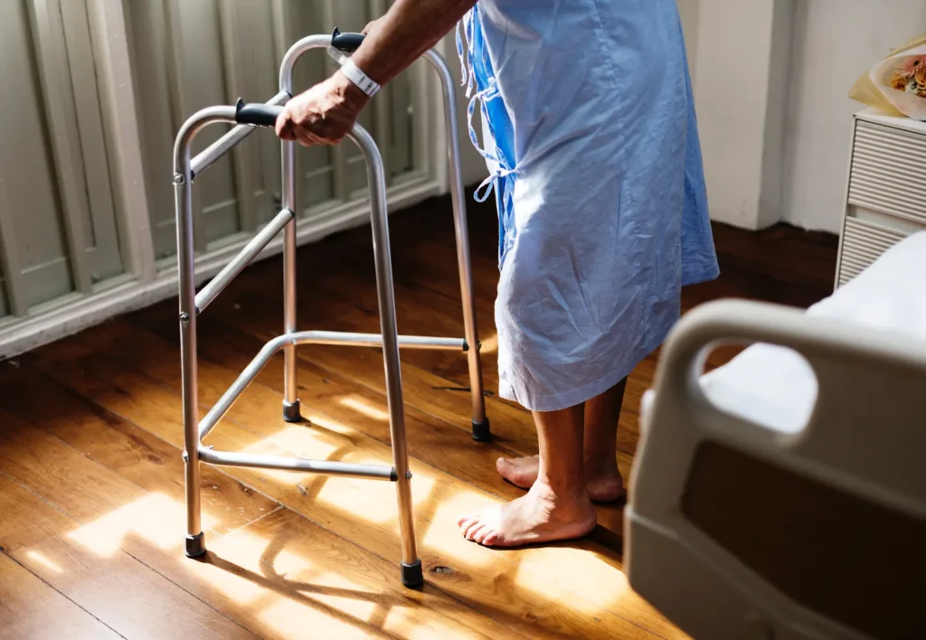 A woman in a walker after Outpatient joint replacement surgery performed in a minimally invasive setting from Rochester Hill Orthopedics.