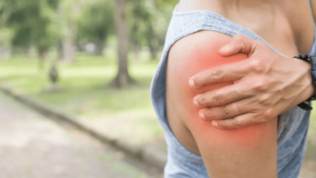Person holding their arm in pain